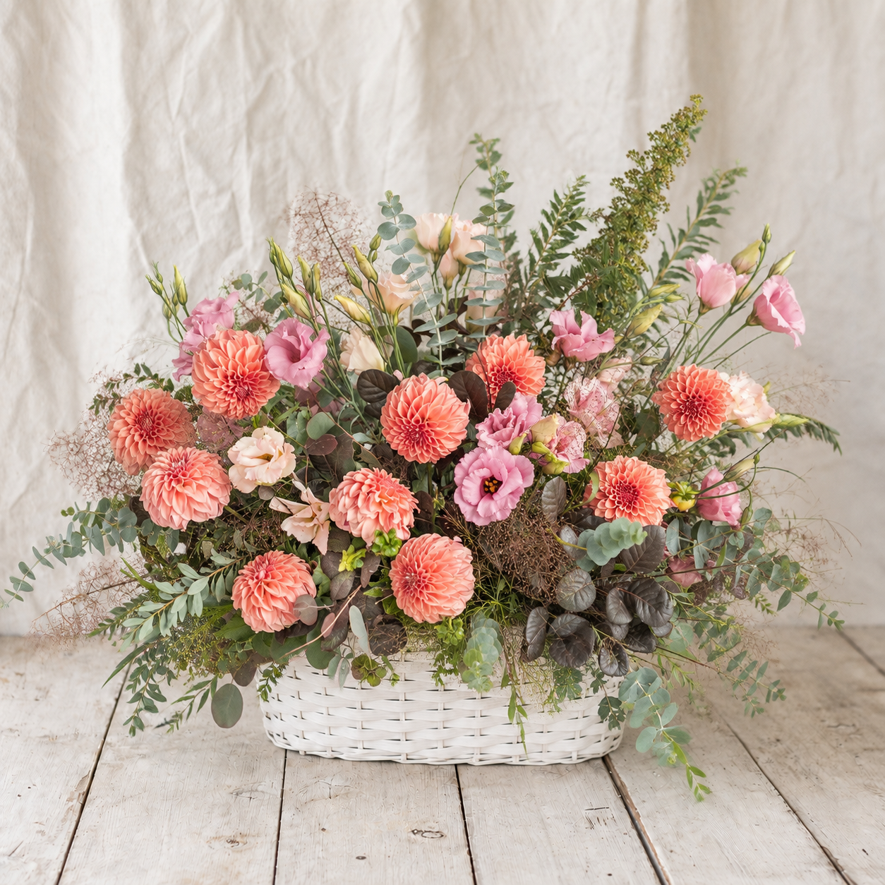 Warm Embrace mid-size coral and pink sympathy flower basket by Rooted Flowers